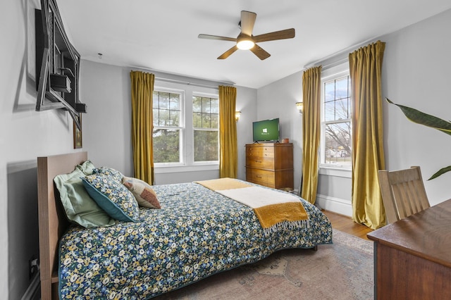 bedroom with hardwood / wood-style floors and ceiling fan