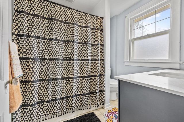 bathroom with a shower with curtain, vanity, toilet, and tile patterned flooring