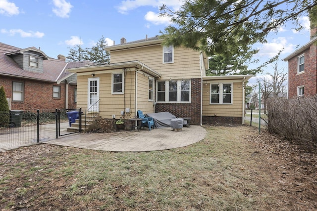 rear view of house featuring a lawn and a patio area