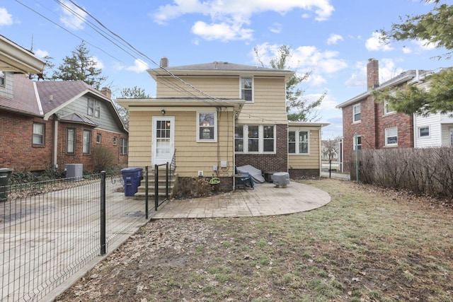 rear view of property featuring a patio and central air condition unit