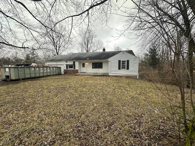 rear view of property with a yard