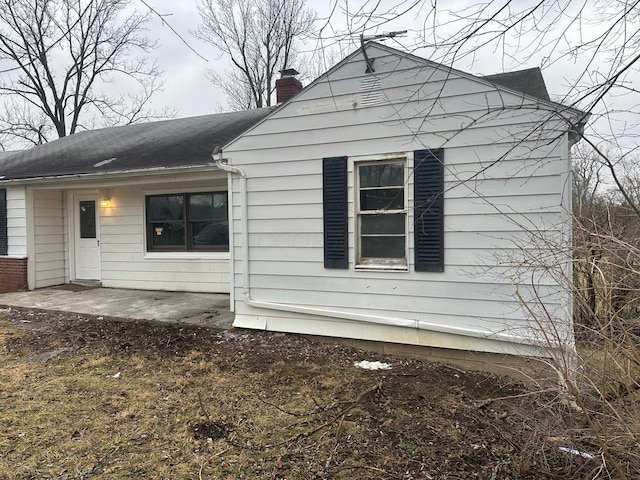 view of side of property with a patio area