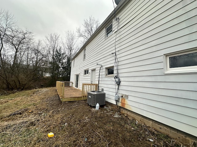 view of side of property with cooling unit and a deck