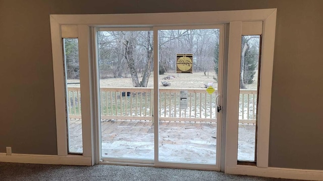 doorway to outside with a healthy amount of sunlight and carpet flooring