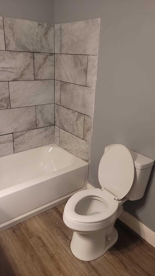 bathroom with hardwood / wood-style flooring and toilet