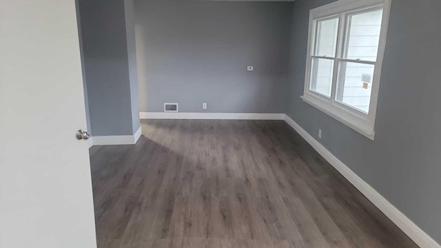 empty room with dark wood-type flooring