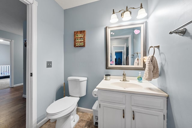 bathroom featuring vanity, toilet, and radiator