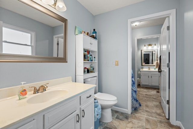 bathroom featuring vanity and toilet