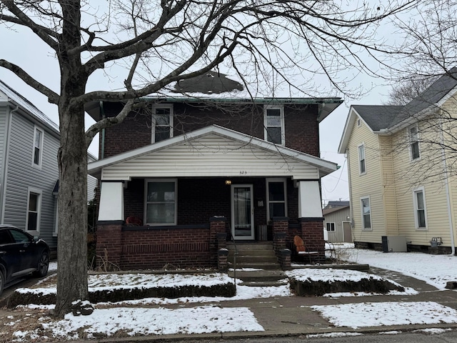 traditional style home featuring brick siding and a porch