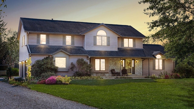 view of front of house featuring a porch and a lawn