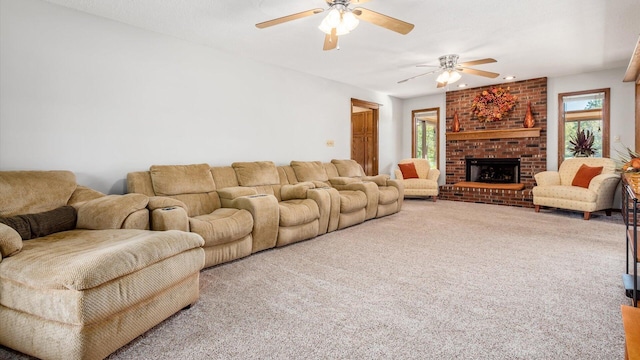 carpeted living room with a brick fireplace, a wealth of natural light, and ceiling fan