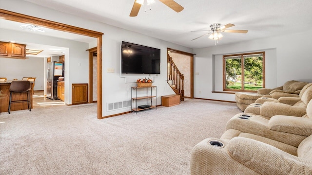 living room with light carpet and ceiling fan