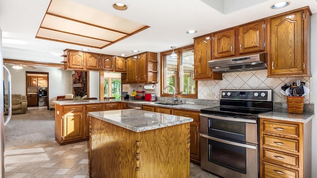 kitchen with sink, double oven range, backsplash, a kitchen island, and kitchen peninsula