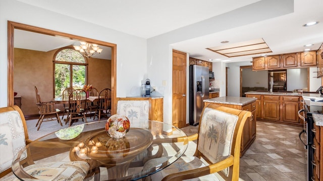 dining room featuring an inviting chandelier and sink