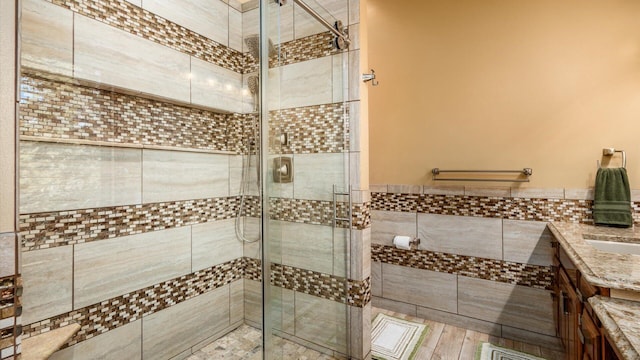 bathroom featuring vanity, tile walls, and an enclosed shower