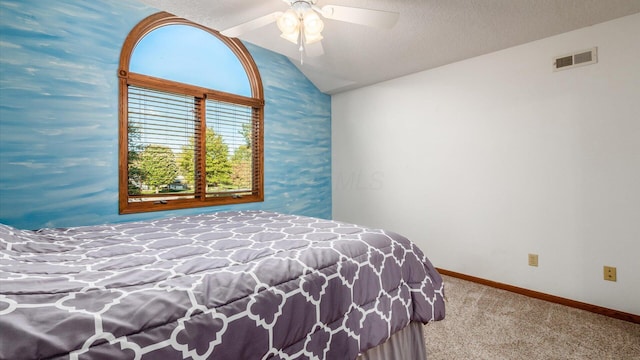 bedroom featuring vaulted ceiling, carpet, ceiling fan, and a textured ceiling