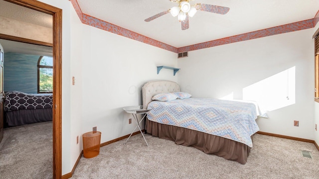 bedroom with ceiling fan and light carpet