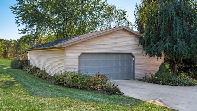 garage featuring a lawn