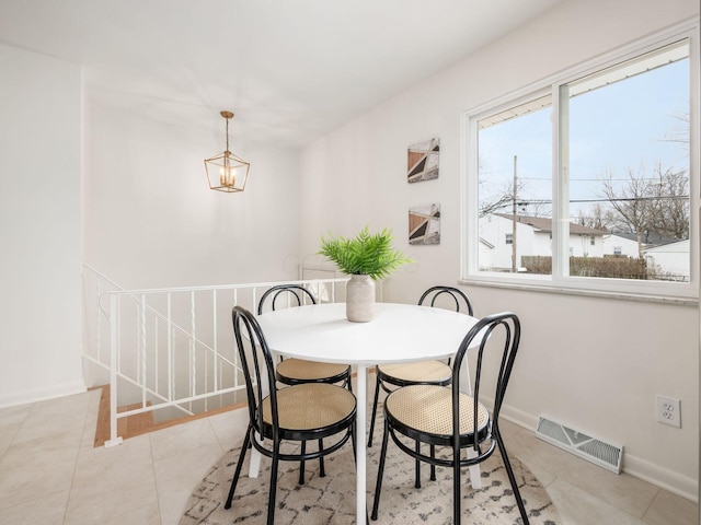 dining space featuring an inviting chandelier and light tile patterned floors