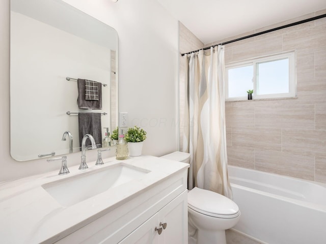 full bathroom featuring vanity, shower / bath combo, and toilet