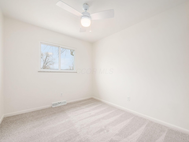 spare room with ceiling fan and carpet floors