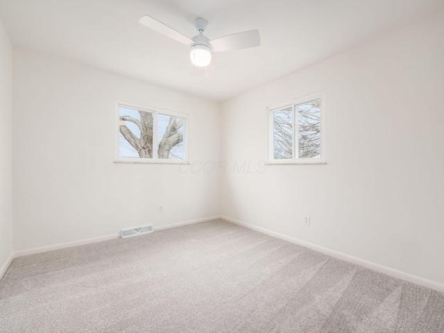 empty room with carpet floors and ceiling fan