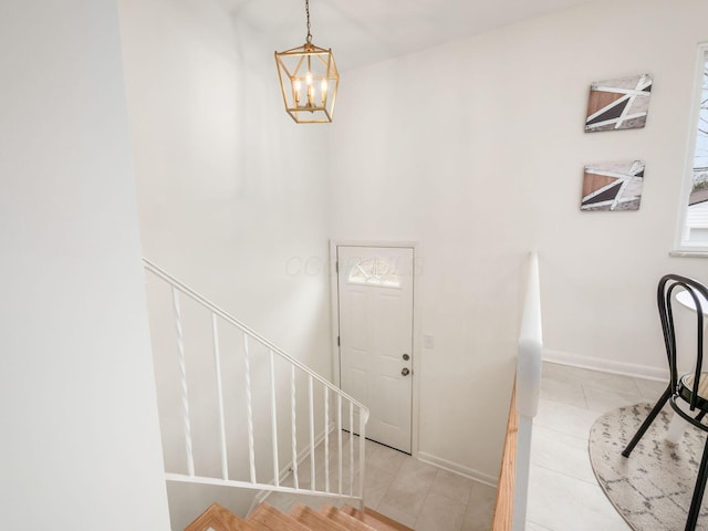 foyer entrance featuring an inviting chandelier and light tile patterned floors