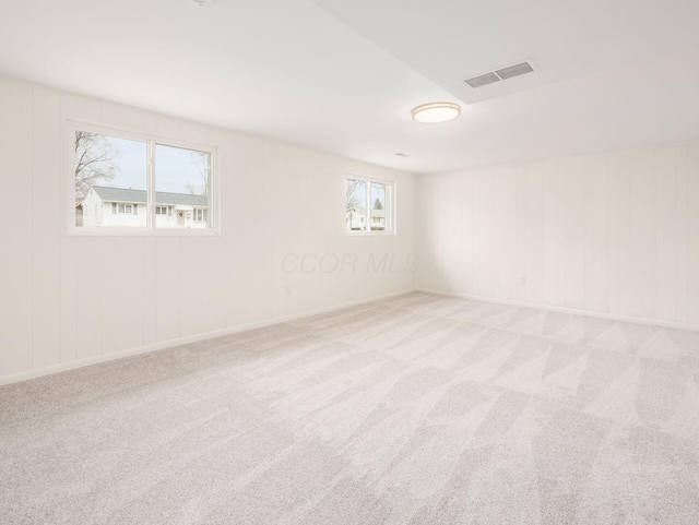 unfurnished room featuring light colored carpet