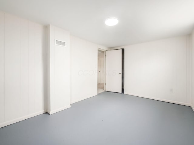 unfurnished room featuring concrete floors