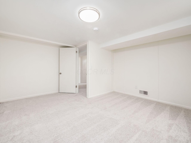 basement featuring light colored carpet