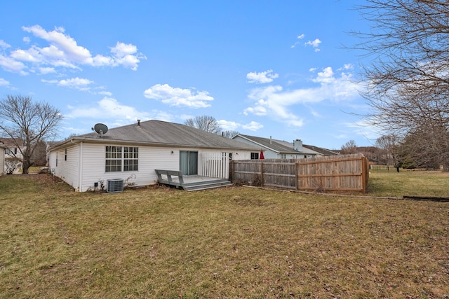 back of property featuring central AC unit and a yard