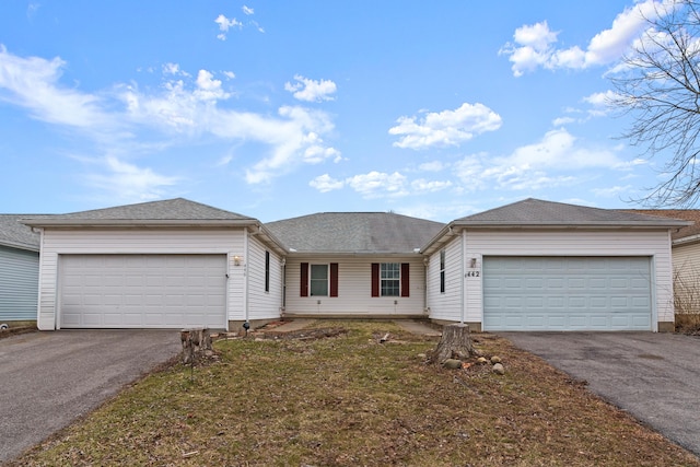 single story home featuring a garage and a front lawn