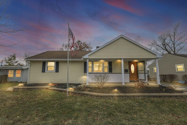 view of front of house featuring a lawn and covered porch