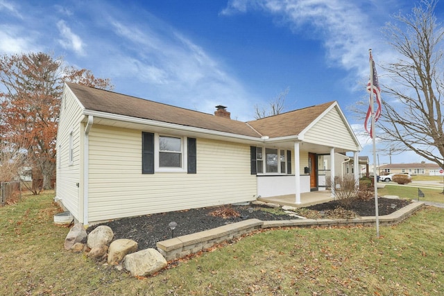 view of front of home with a patio area and a front lawn