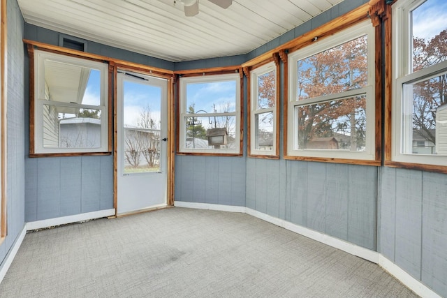 unfurnished sunroom featuring ceiling fan