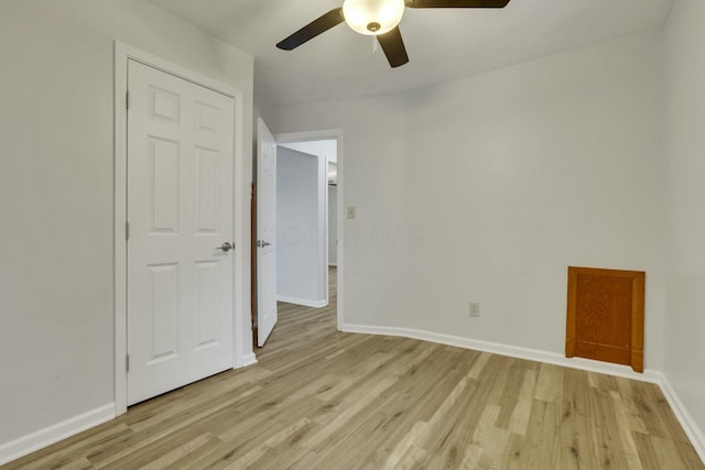 empty room featuring ceiling fan and light wood-type flooring