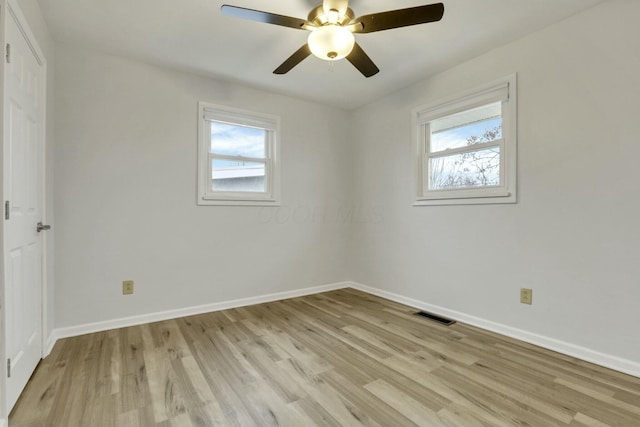 unfurnished room featuring ceiling fan, light hardwood / wood-style flooring, and a healthy amount of sunlight