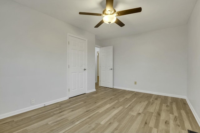 empty room featuring ceiling fan and light wood-type flooring