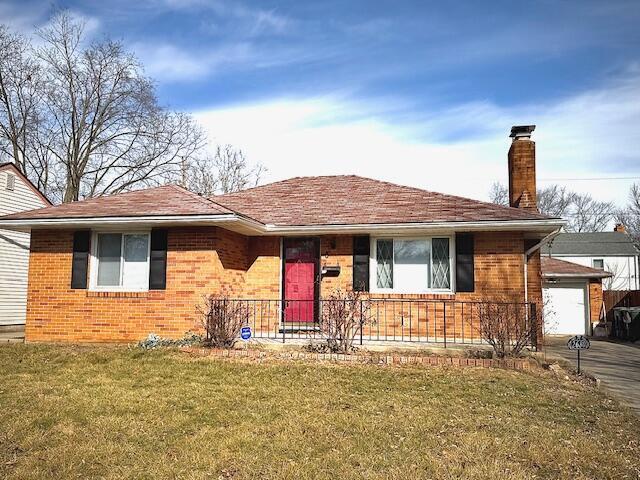 view of front of property with a garage and a front lawn