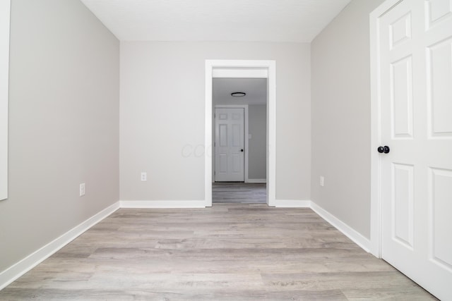 unfurnished room with light wood-type flooring