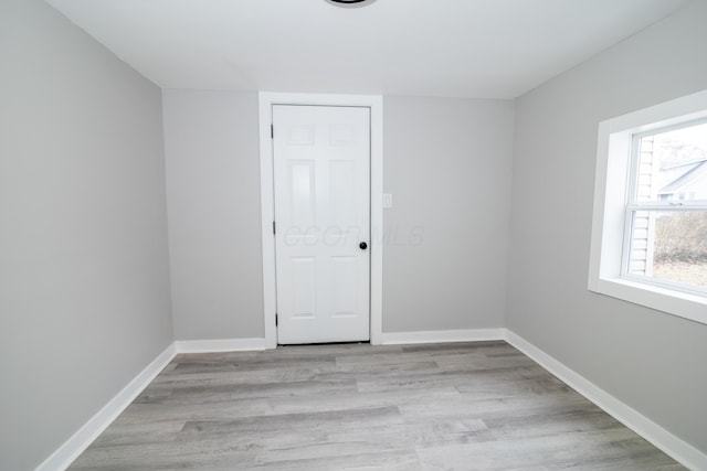 unfurnished room with light hardwood / wood-style floors