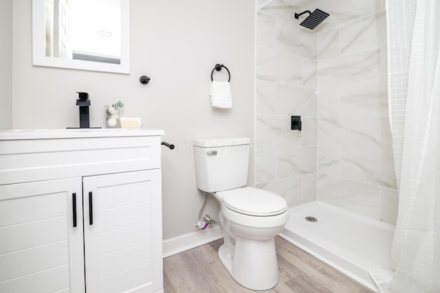 bathroom featuring wood-type flooring, toilet, vanity, and a shower with curtain