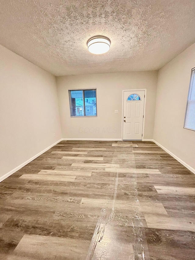 entrance foyer with wood-type flooring and a textured ceiling