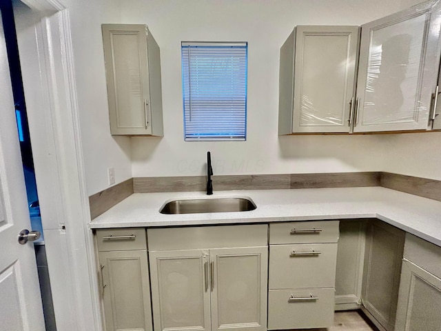 kitchen with gray cabinetry and sink