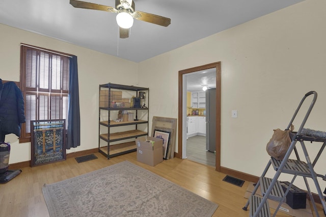 interior space with ceiling fan and light wood-type flooring