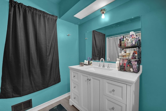 bathroom with vanity and wood-type flooring