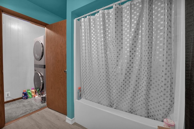 bathroom featuring stacked washer / drying machine and hardwood / wood-style floors