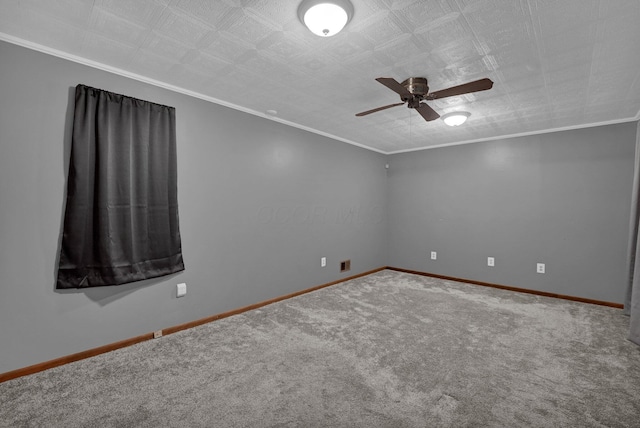 empty room with ornamental molding, carpet floors, and ceiling fan