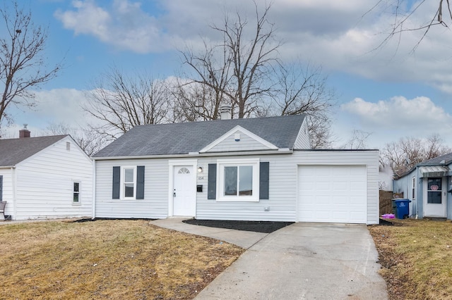 view of front of house with a garage and a front lawn