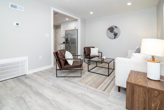 living room with light hardwood / wood-style flooring